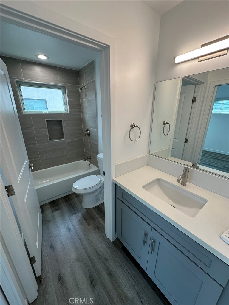 25134-25200 Frampton Avenue Harbor City, CA 90710 - Photo 11 of 11 a bathroom with a double vanity sink toilet mirror and bathtub