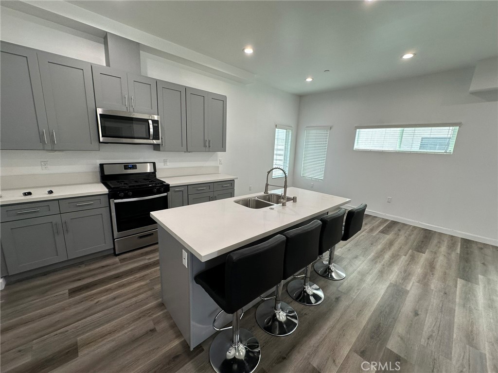 25134-25200 Frampton Avenue Harbor City, CA 90710 - Photo 6 of 11 a kitchen with a sink refrigerator and cabinets