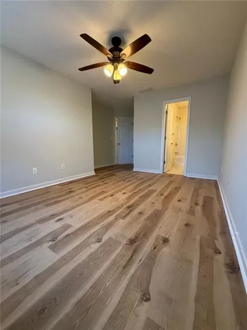 a view of a livingroom with a ceiling fan and window