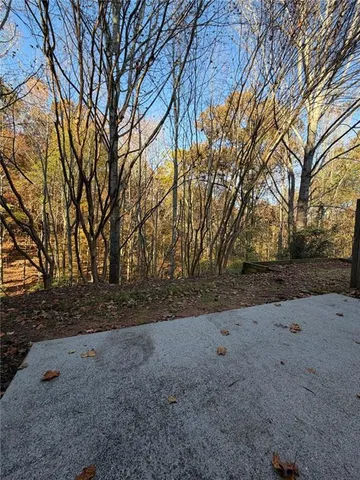 a backyard of a house with large trees