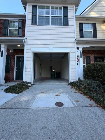 a view of a house with a yard and garage