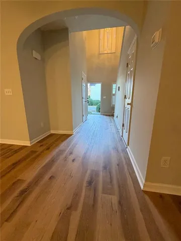 a view of a room with wooden floor and a window