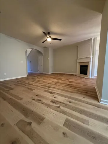 a view of empty room with fireplace and fan