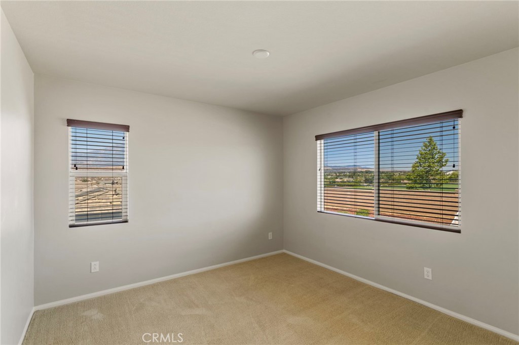 11462 Jacobsen Road Beaumont, CA 92223 - Photo 13 of 45 a view of an empty room with a window