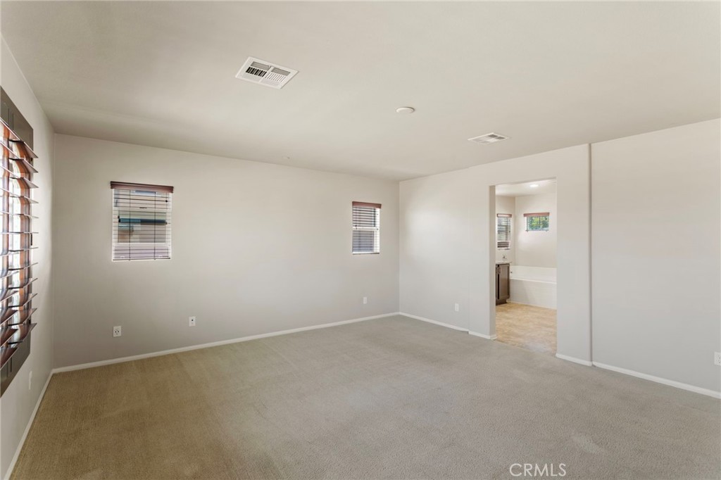 11462 Jacobsen Road Beaumont, CA 92223 - Photo 16 of 45 a view of an empty room with a window