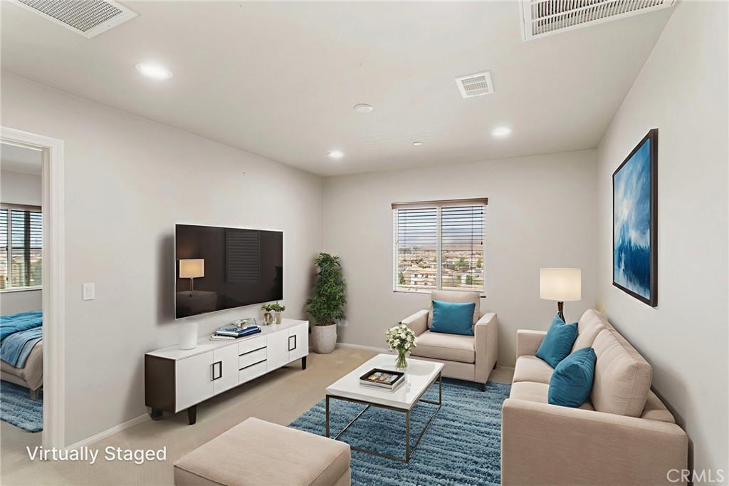 11462 Jacobsen Road Beaumont, CA 92223 - Photo 20 of 45 a living room with furniture and a flat screen tv