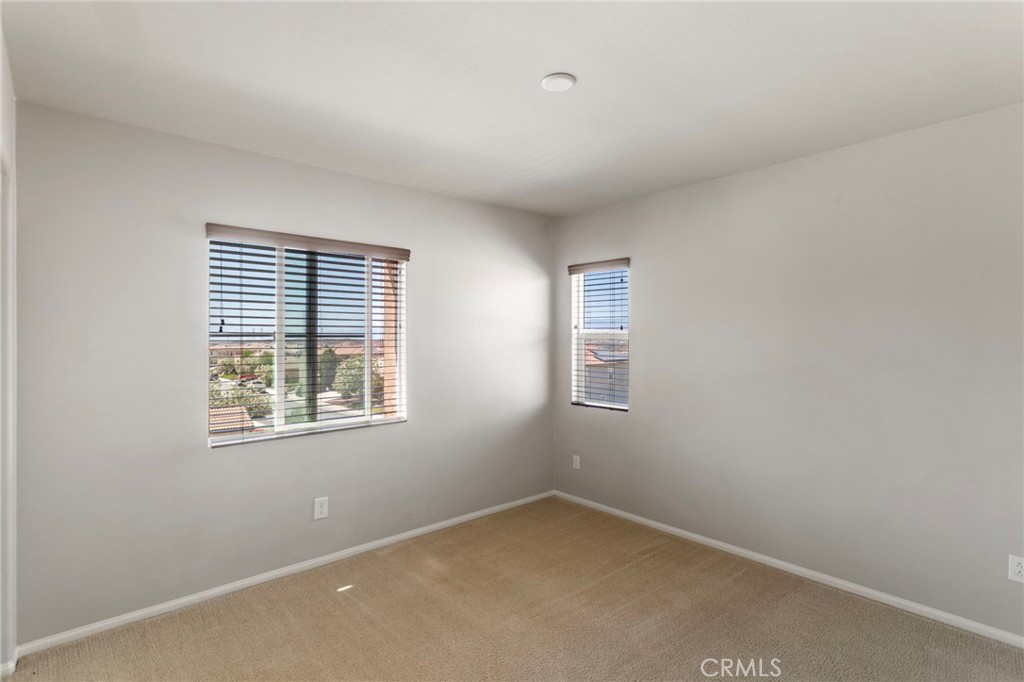11462 Jacobsen Road Beaumont, CA 92223 - Photo 22 of 45 an empty room with a window