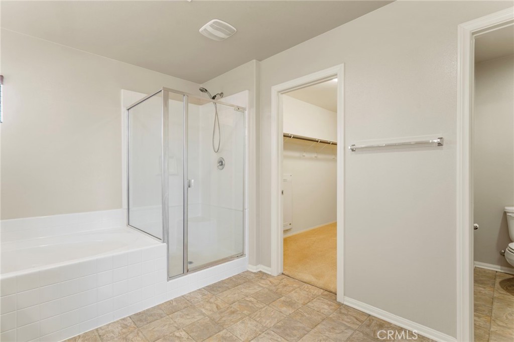 11462 Jacobsen Road Beaumont, CA 92223 - Photo 26 of 45 a bathroom with a tub and shower