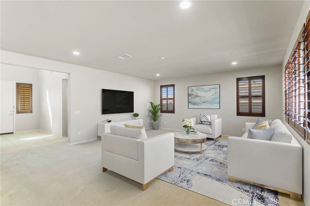 11462 Jacobsen Road Beaumont, CA 92223 - Photo 5 of 45 a living room with furniture and a flat screen tv