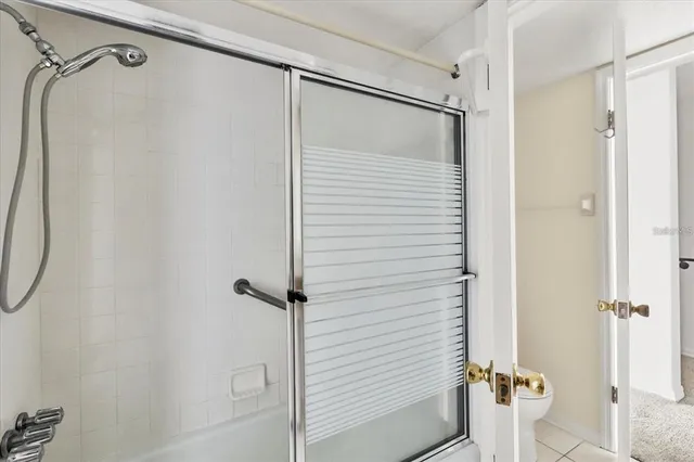 a bathroom with a shower and a glass door
