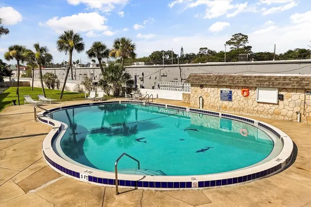 a view of a swimming pool with an outdoor seating