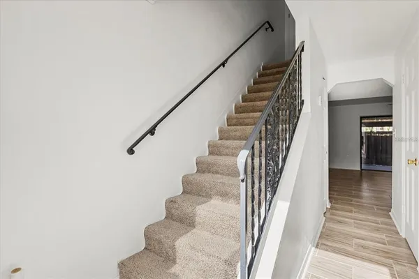 a view of entryway and hall with wooden floor
