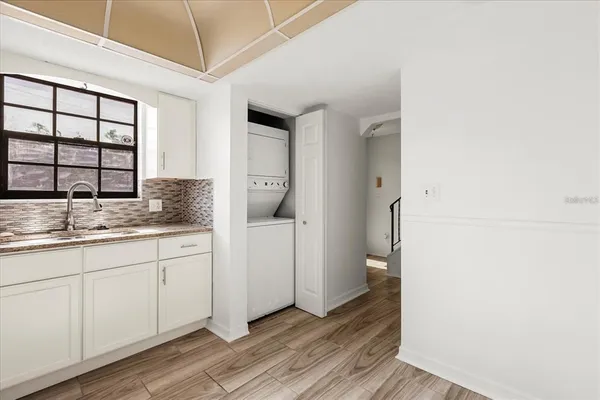 a kitchen with granite countertop white cabinets and white appliances