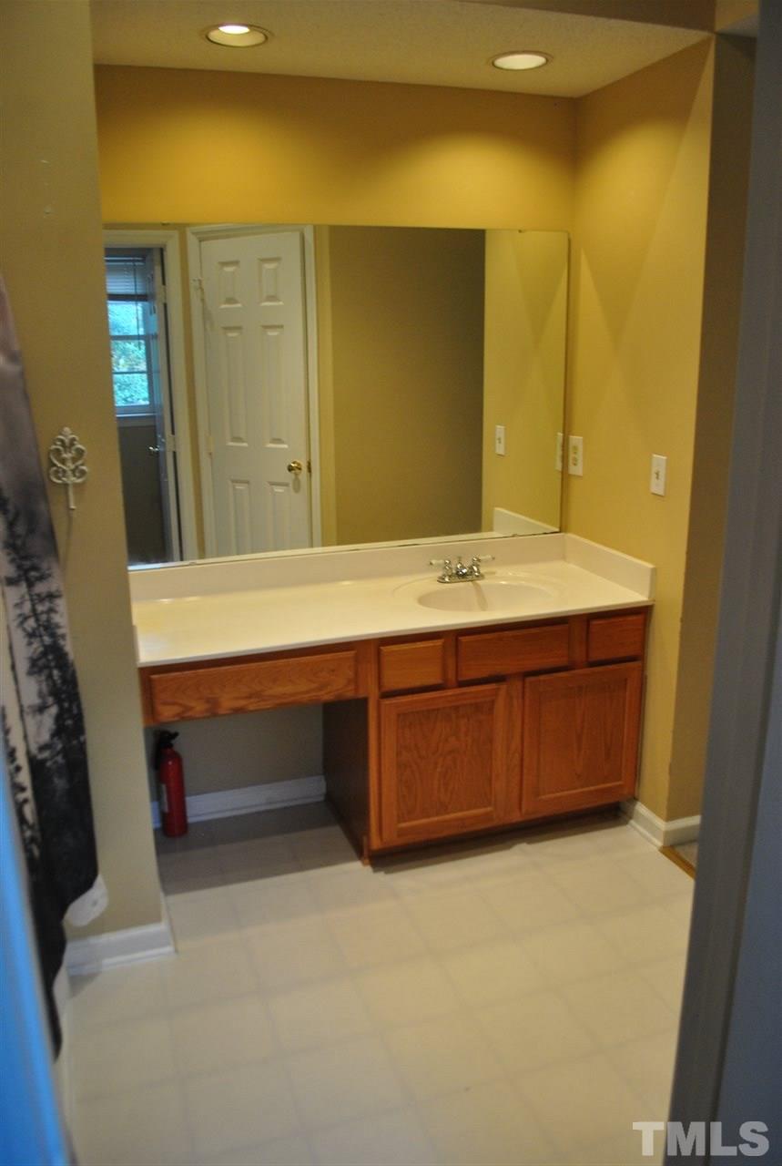 3424 Ribcowski Court Raleigh, NC 27616 - Photo 14 of 20 a room with a wooden table and chair