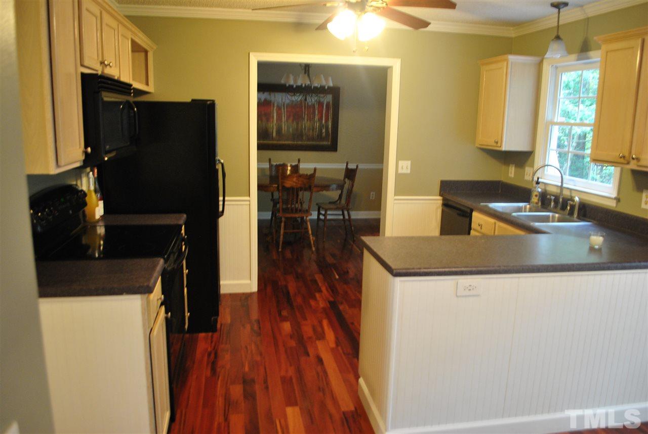 3424 Ribcowski Court Raleigh, NC 27616 - Photo 5 of 20 a kitchen with granite countertop a refrigerator and a sink