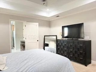 a bedroom with a bed and a flat screen tv in it