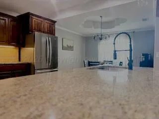 a view of a kitchen with a sink and a refrigerator