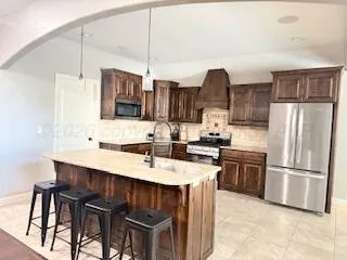 a kitchen with stainless steel appliances a sink stove and refrigerator