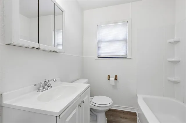 a bathroom with a sink a toilet and bathtub