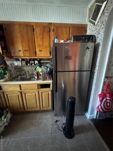 a white refrigerator freezer sitting inside of a kitchen