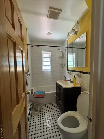 a bathroom with a sink toilet vanity and mirror