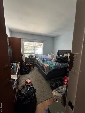 a bedroom with bed and a window