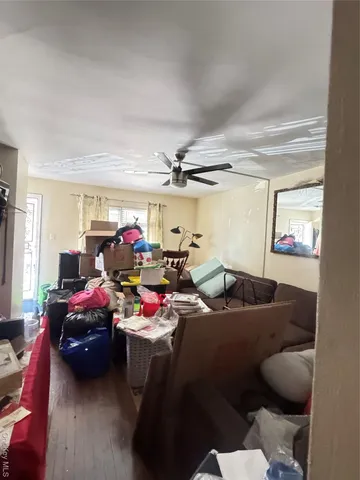 a gym room with furniture a rug and a window