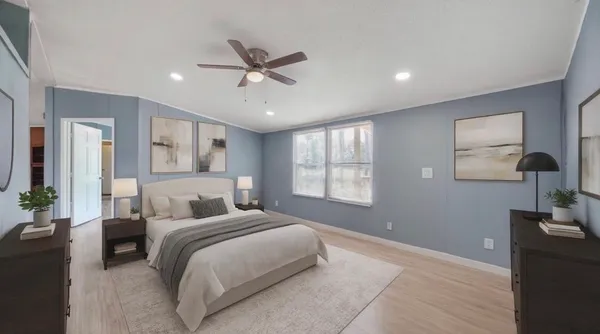a bedroom with a large bed and a chandelier