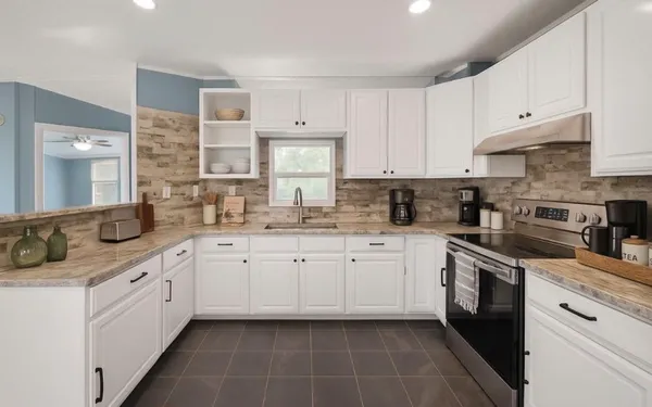 a kitchen with cabinets appliances and a sink