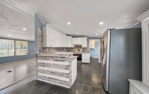 a view of kitchen with stainless steel appliances cabinets and a counter top space