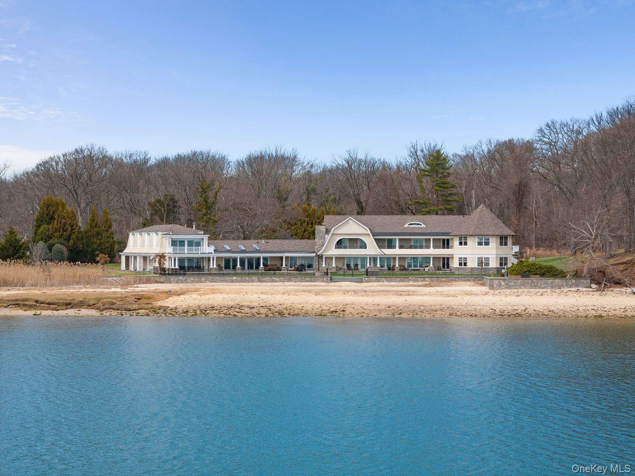 33 Beach Road Northport, NY 11768 - Photo 46 of 50 a front view of a house with a garden and trees