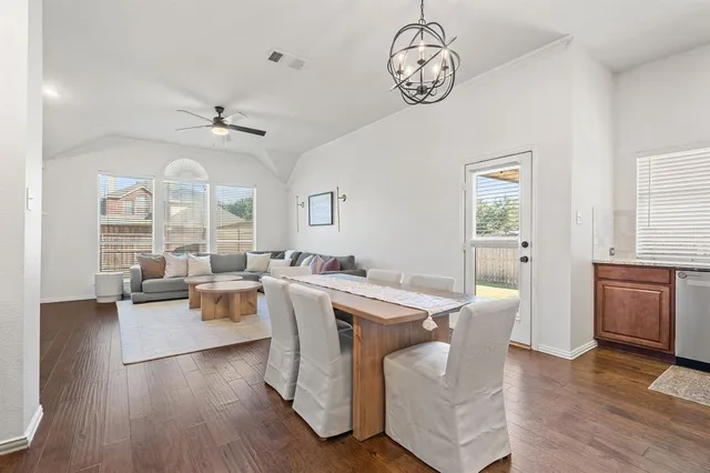 a view of a dining room with furniture wooden floor and a chandelier