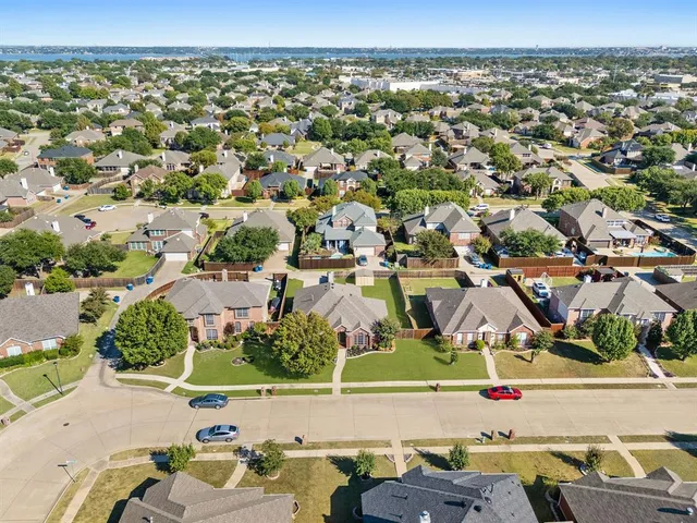 an aerial view of a houses with a swimming pool