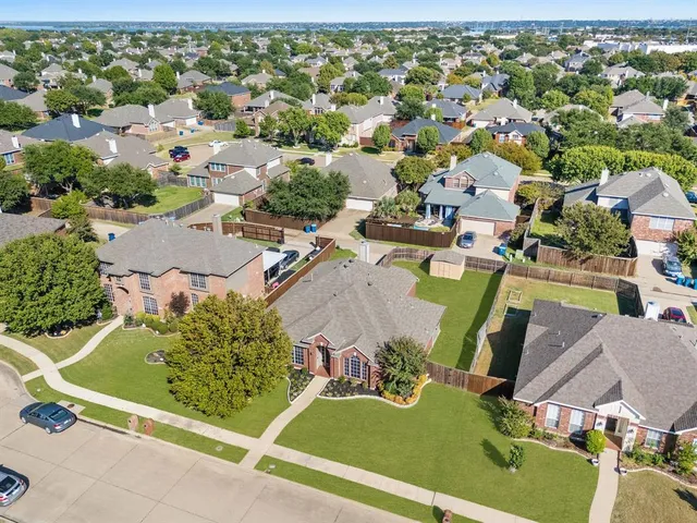 an aerial view of residential houses with outdoor space