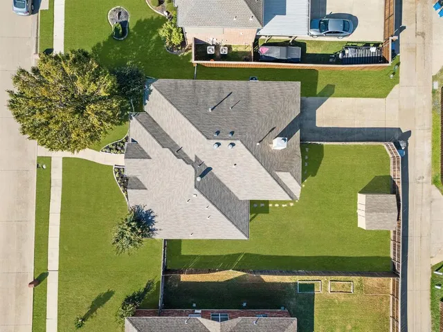an aerial view of a house with outdoor space