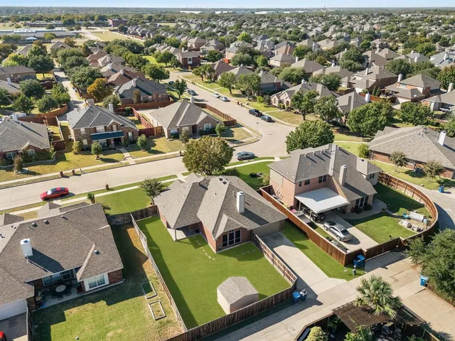 an aerial view of a house with a swimming pool