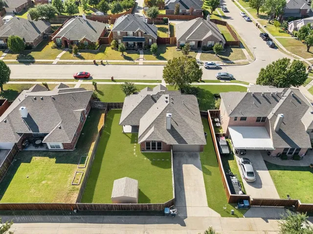 an aerial view of a house with a swimming pool