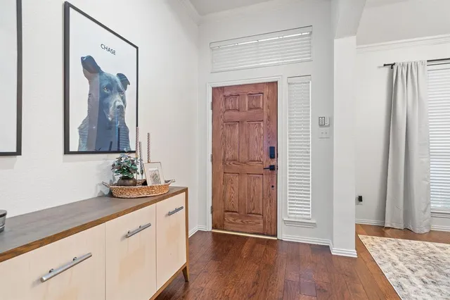 a hallway with view of wooden floor and cabinet
