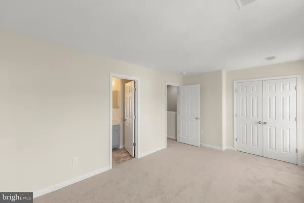 a view of an empty room and closet area