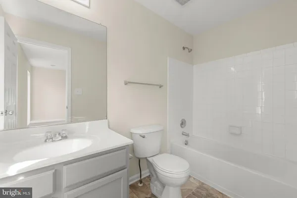 a bathroom with a sink toilet vanity and shower