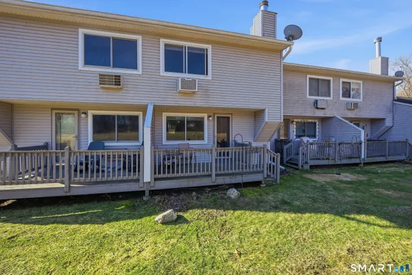a view of a house with a yard and deck