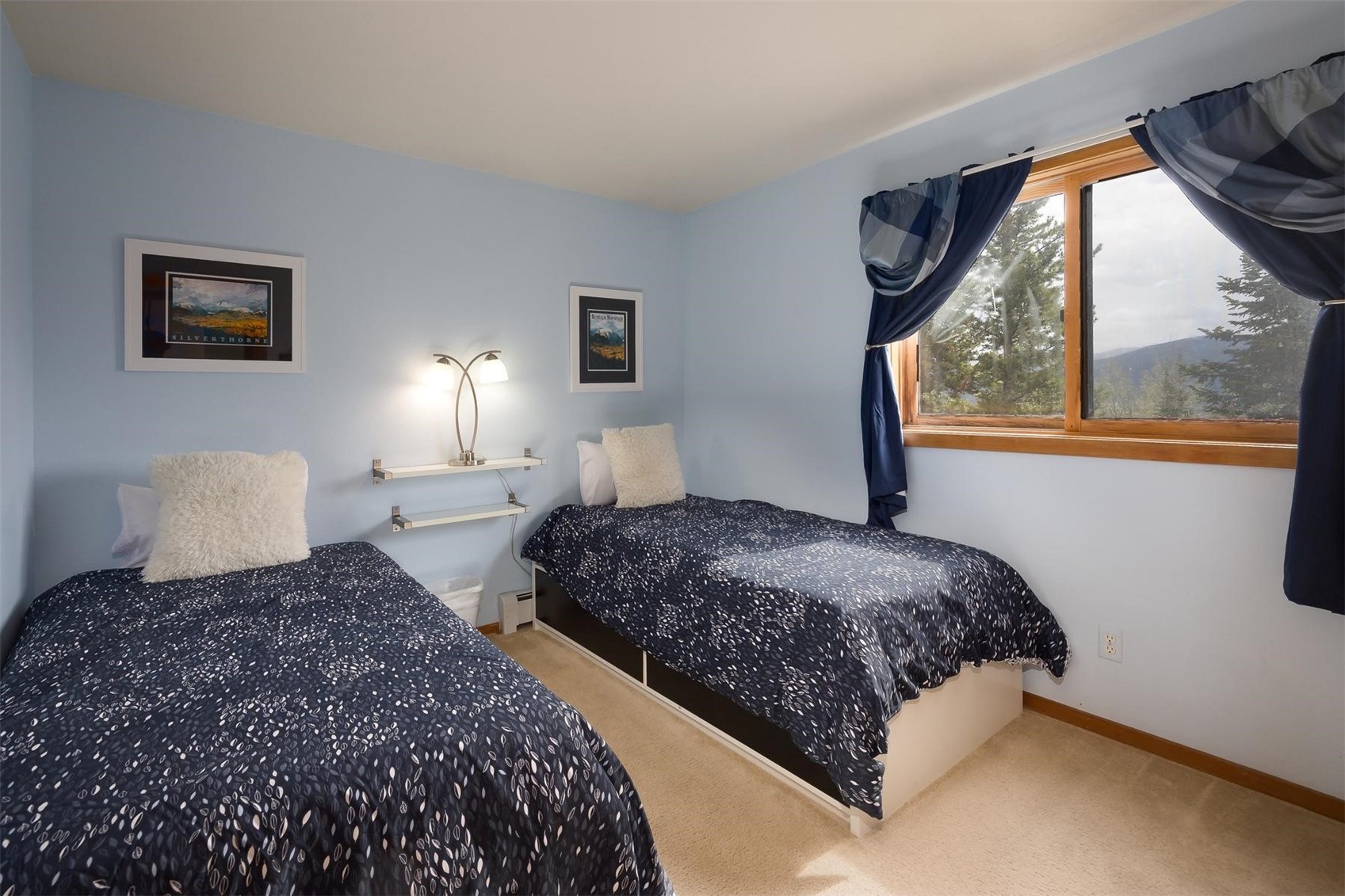 91100 Ryan Gulch Road, Unit 91105 Silverthorne, CO 80498 - Photo 23 of 49 a bedroom with double bed and a window