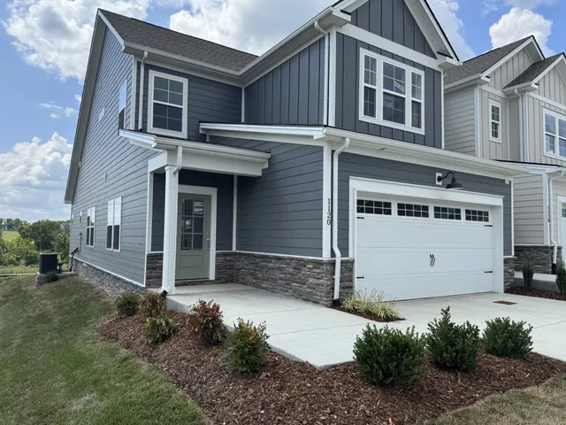 a front view of a house with a yard