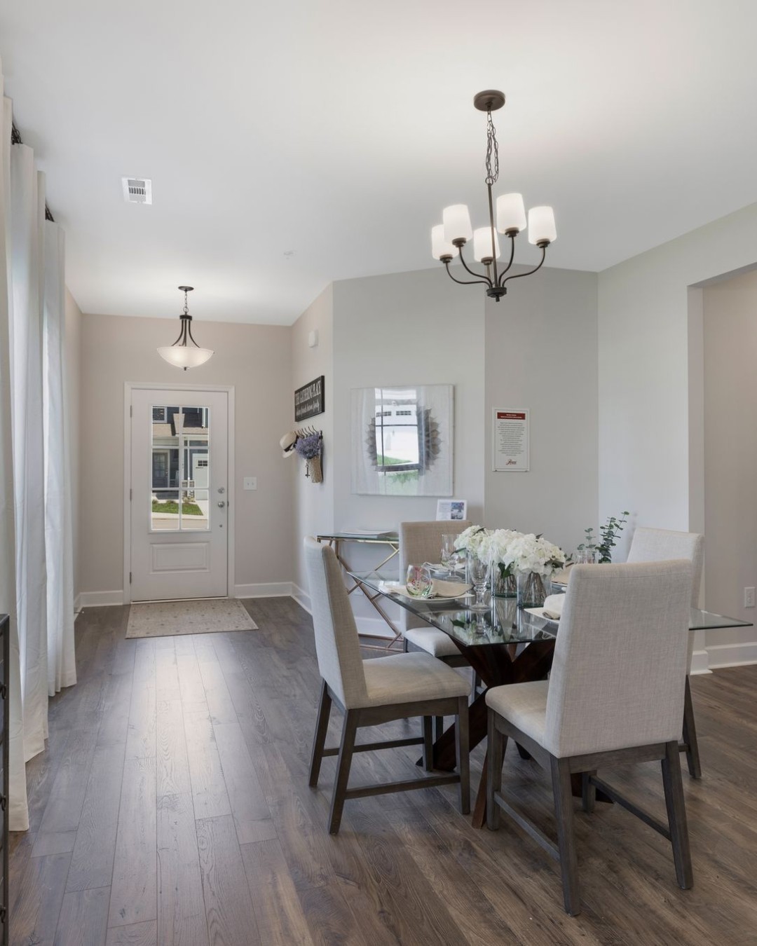1120 June Wilde Ridge Spring Hill, TN 37174 - Photo 3 of 15 a dining room with wooden floor a chandelier a wooden table and chairs