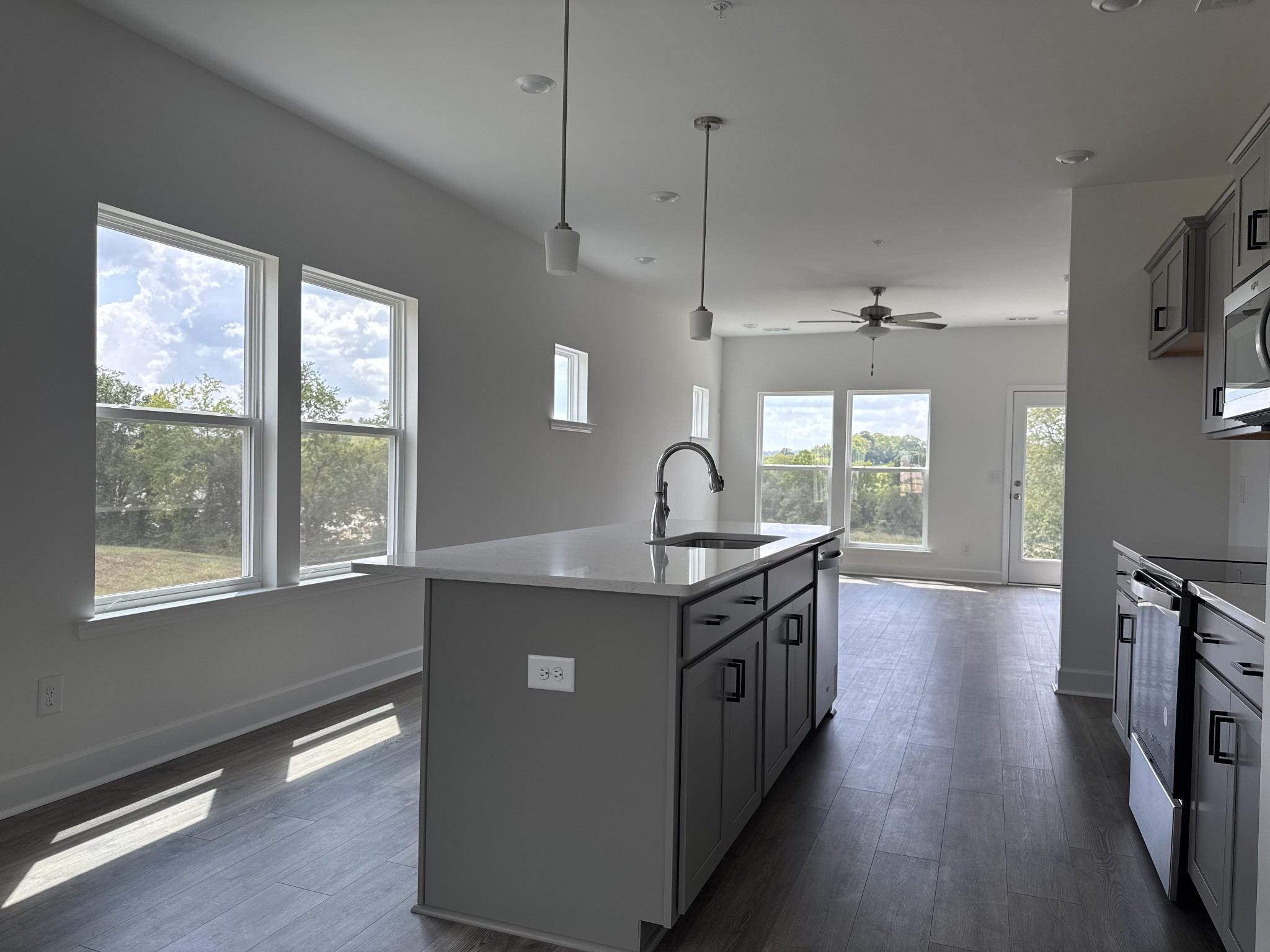 1120 June Wilde Ridge Spring Hill, TN 37174 - Photo 6 of 15 a kitchen with stainless steel appliances granite countertop a sink a stove and a wooden floors