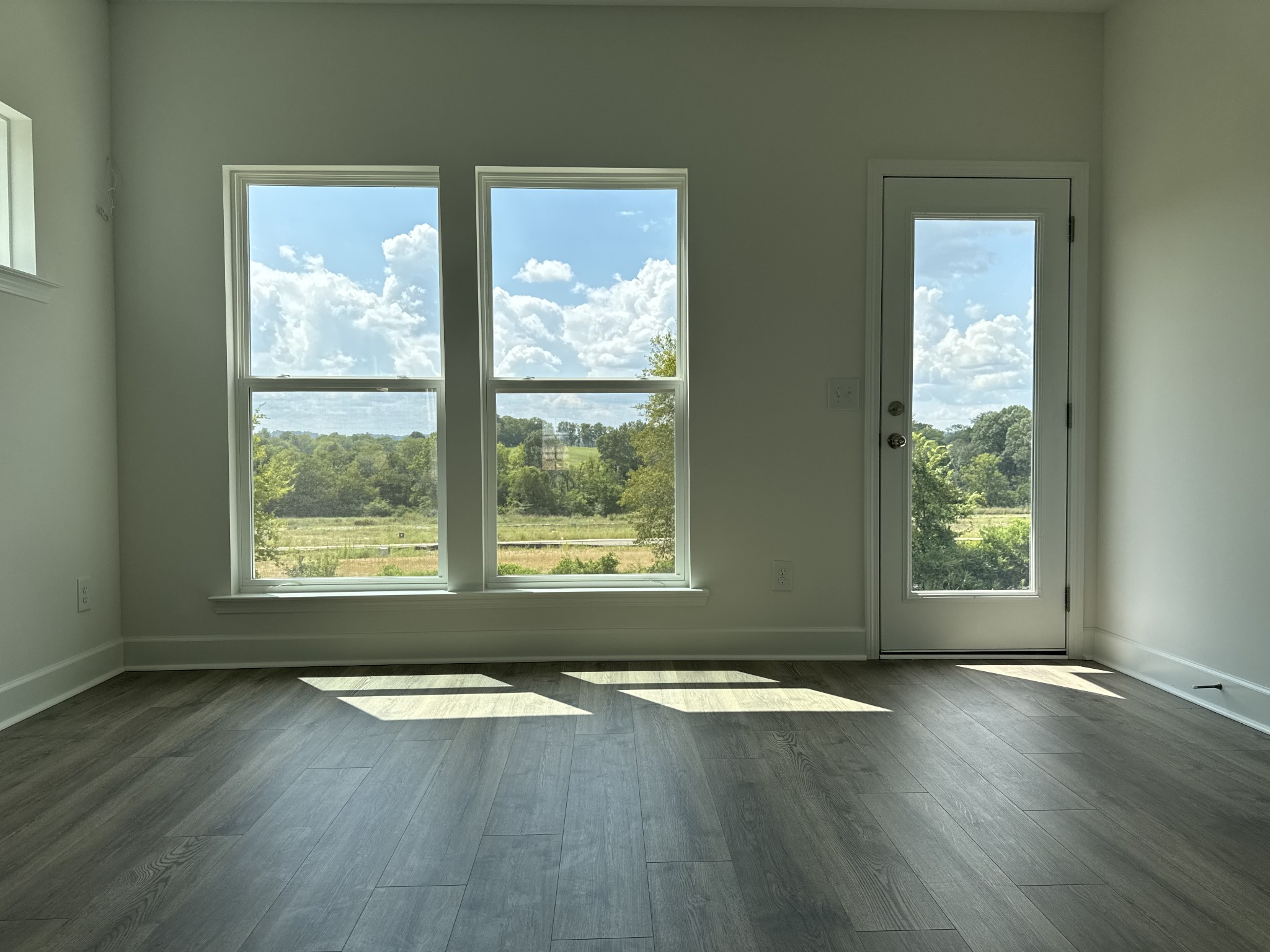1120 June Wilde Ridge Spring Hill, TN 37174 - Photo 8 of 15 an empty room with wooden floor and windows