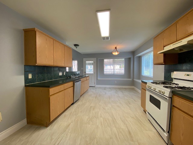 1512 Lorson Loop Round Rock, TX 78665 - Photo 17 of 29 a kitchen with stainless steel appliances granite countertop a stove a sink and a refrigerator