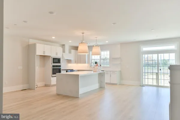 a kitchen with stainless steel appliances a refrigerator and wooden cabinets