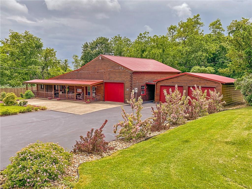 2022 Ridge Rd Extension Ambridge, PA 15003 - Photo 1 of 22 a front view of a house with garden