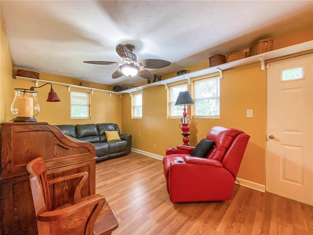 2022 Ridge Rd Extension Ambridge, PA 15003 - Photo 11 of 22 a living room with furniture a ceiling fan and a wooden floor